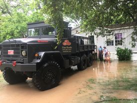 Tim helping local victims during a flood