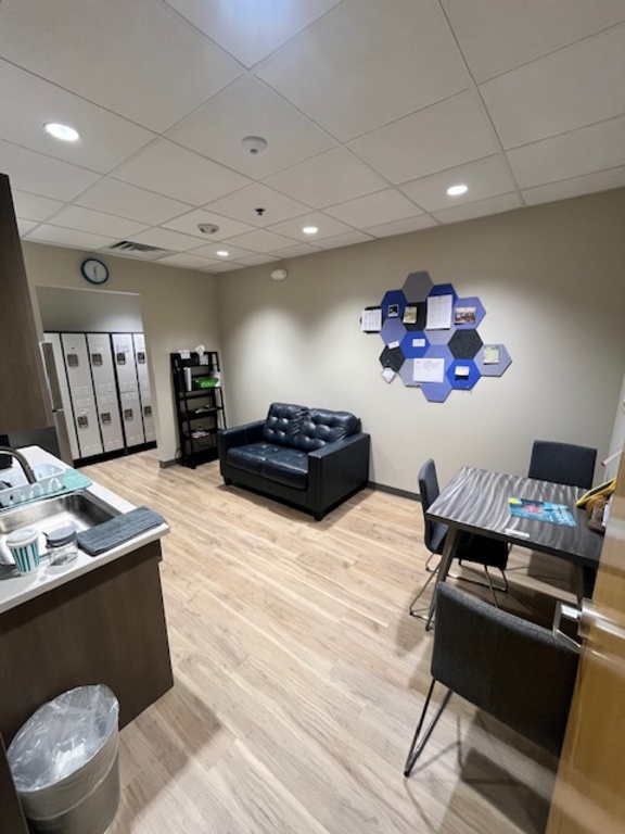 Spacious break room for staff with full size fridge