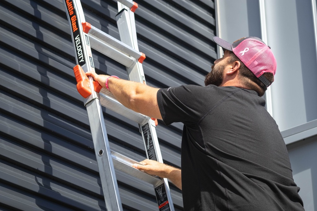 Project Manager climbing a ladder.
