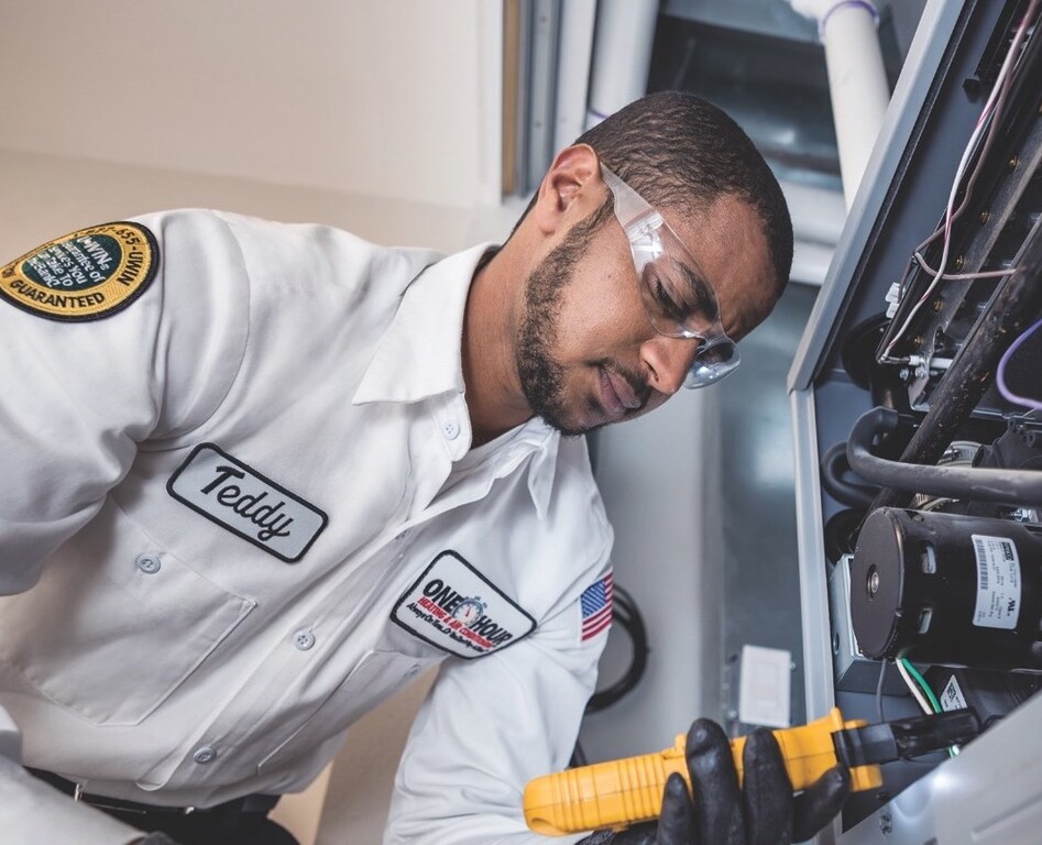 Tech working inside on furnace