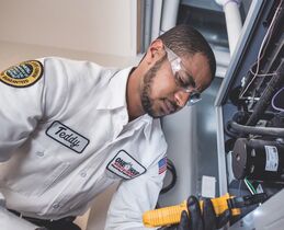 Tech working inside on furnace