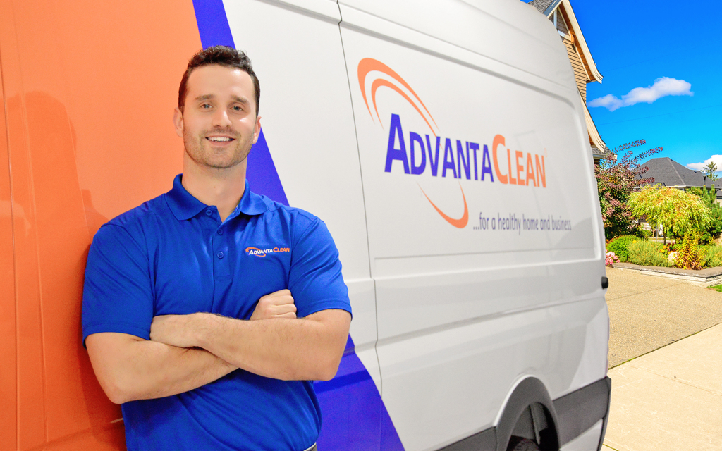 Employee posing in front of car marketing image