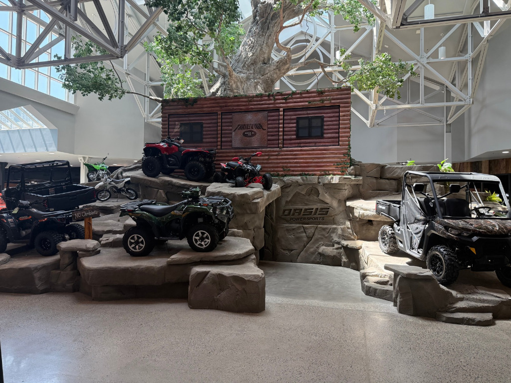 Indoor mountain and tree on the showroom floor at Oasis Powersports.